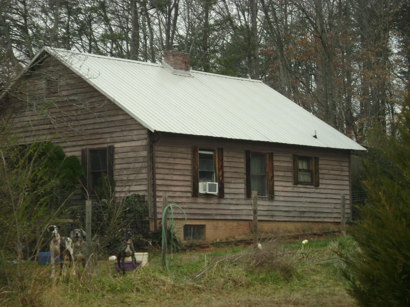 White metal roof on an old wood sided farmhouse, from a Metal Roof Installation job in Mukwonago