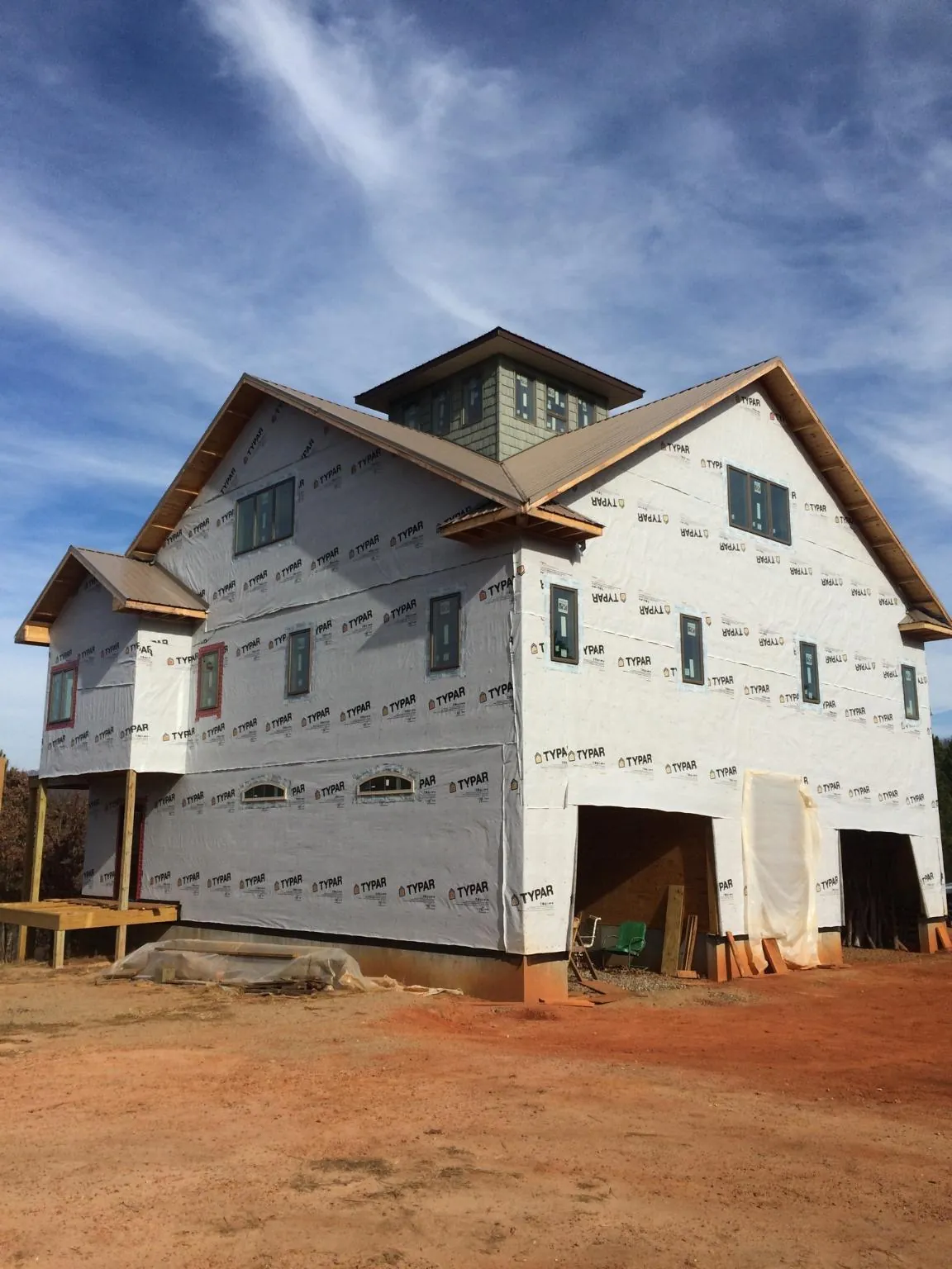 New two story house under construction with a cupola and gabled roofs in Mukwonago